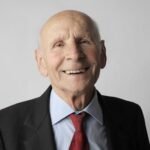 Portrait of a happy senior man in a suit. Ideal for lifestyle and senior care imagery.